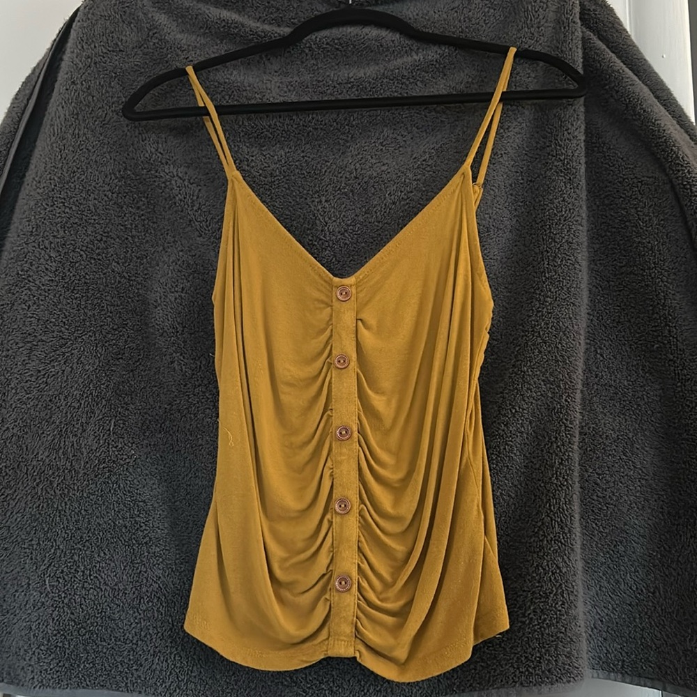 Mustard yellow color, tank top, buttons lined to the middle